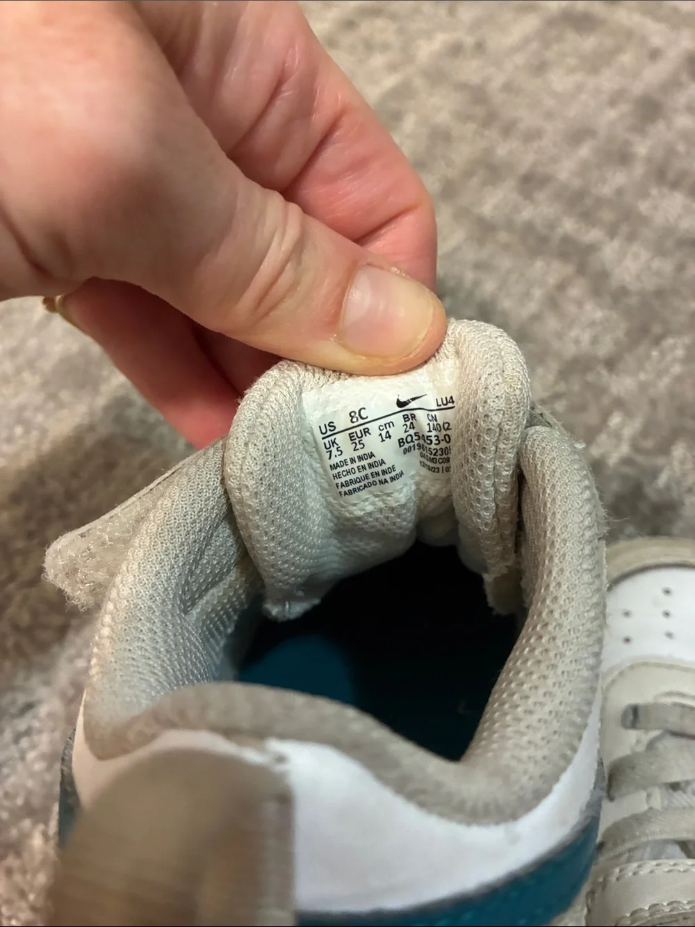 Nike Kids White Sneakers with Teal Swoosh and Orange Logo